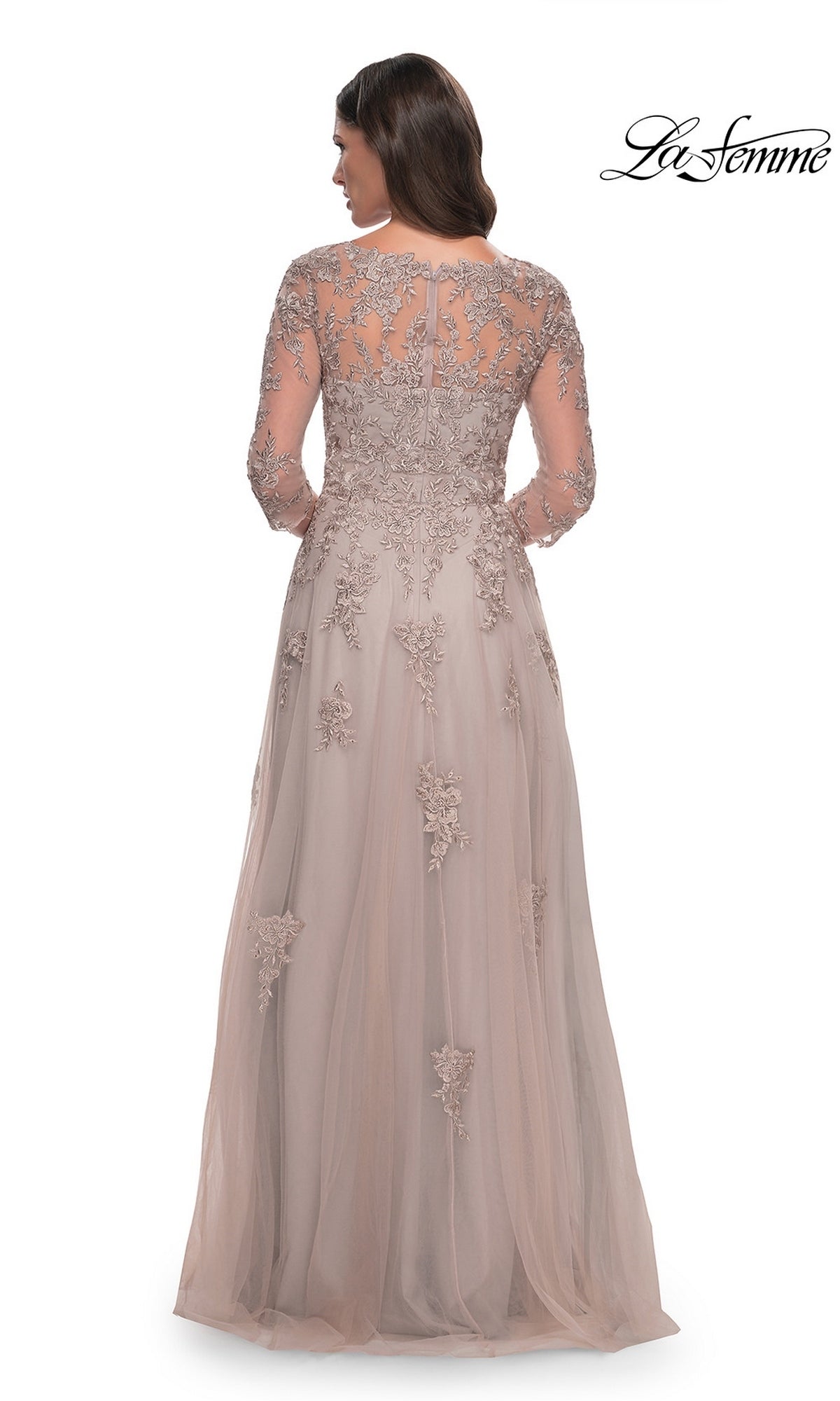 A woman wears a La Femme 30398 long formal dress, a taupe, floor-length A-line gown with long sleeves, an illusion neckline, and intricate floral lace embroidery.