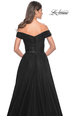 A woman is seen from the back wearing the La Femme Off-Shoulder Long Prom Ball Gown 30498, an elegant dress with a fitted bodice and flowing skirt. The La Femme logo appears in the upper right corner.
