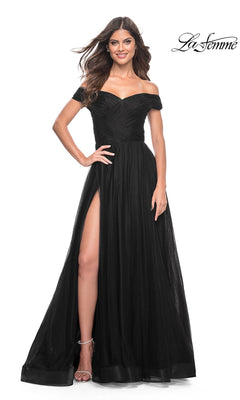 A woman smiles while wearing the La Femme Off-Shoulder Long Prom Ball Gown 30498 in black, featuring a thigh-high slit. The La Femme logo appears in the top right corner.