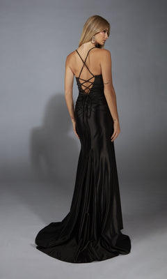 A woman faces away in the Aerie Couture 304, a long black prom dress with a lace-up back, satin fabric, and slight train, set against a plain gray background.