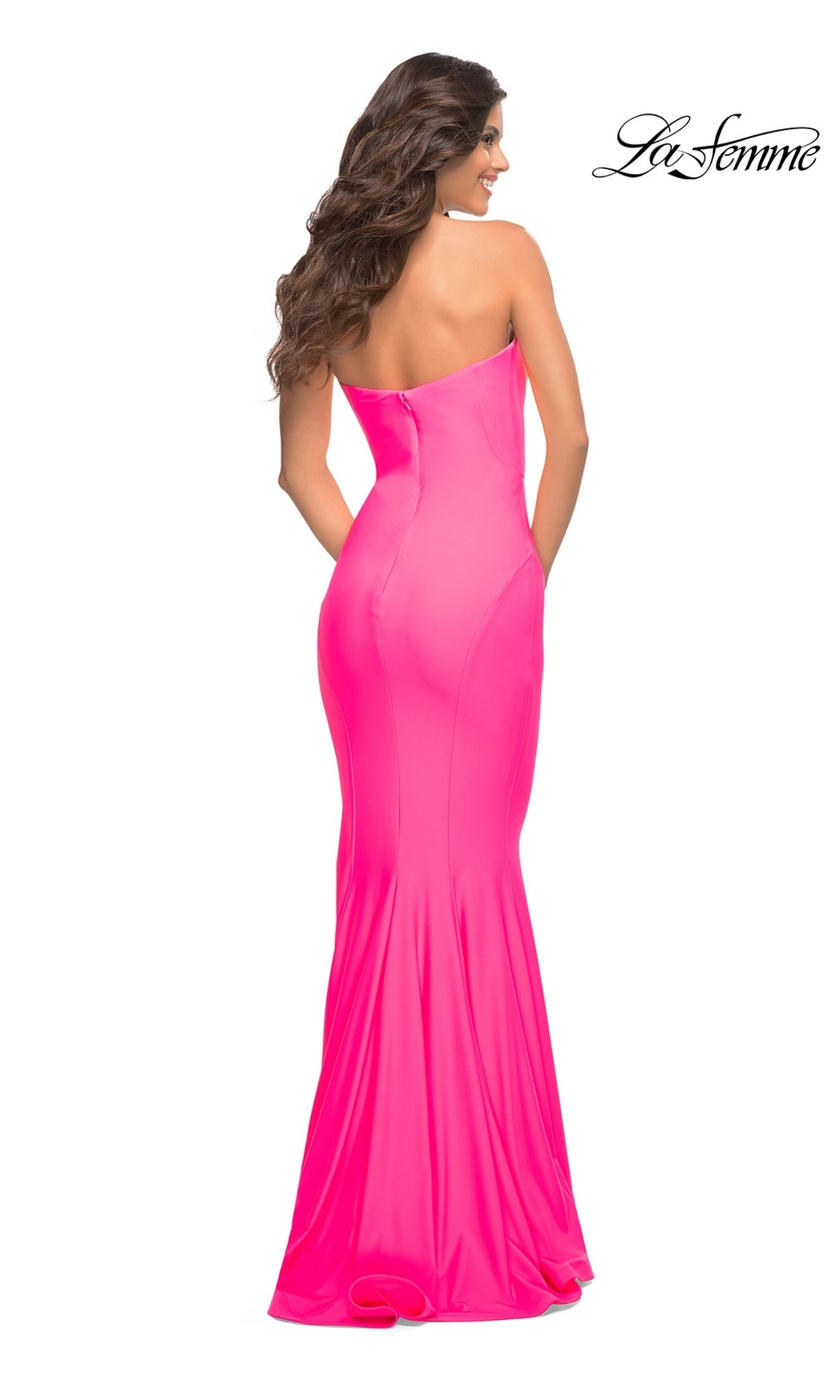 Back view of a woman wearing a floor-length, strapless neon pink mermaid La Femme 30648 prom dress.
