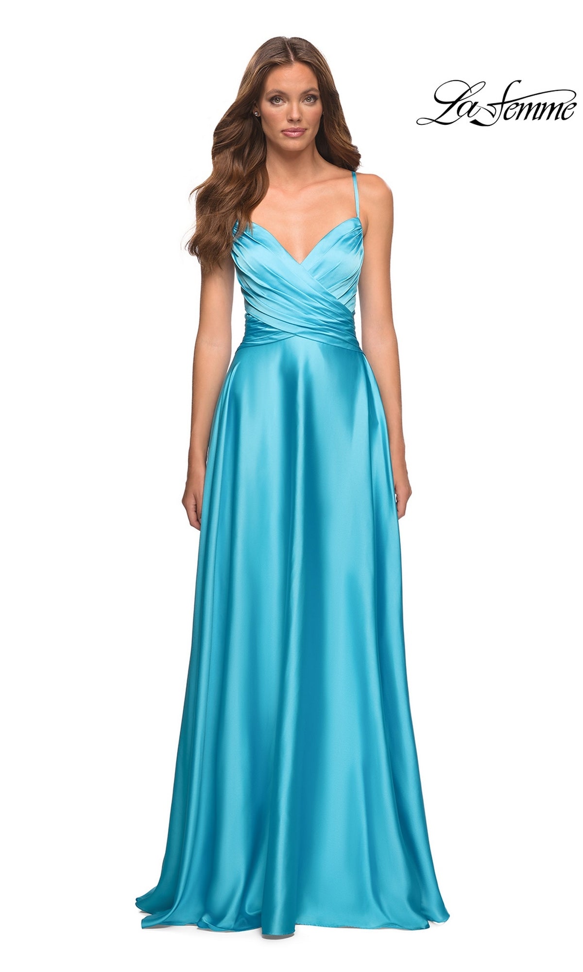A woman wearing a bright blue Long Prom Dress: La Femme 30662 with a floor-length A-line skirt, V-neckline, spaghetti straps, and a pleated crossover bodice.