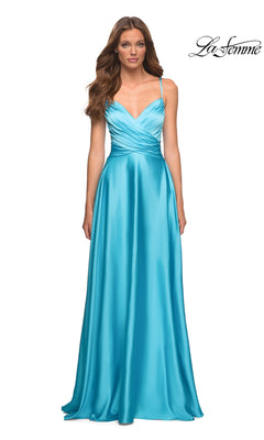 A woman wearing a bright blue Long Prom Dress: La Femme 30662 with a floor-length A-line skirt, V-neckline, spaghetti straps, and a pleated crossover bodice.
