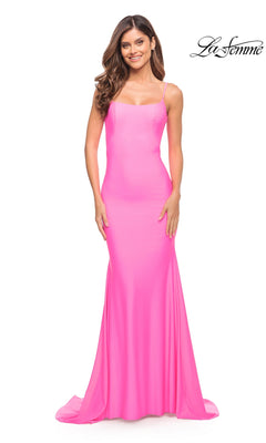 A woman wearing the hot pink Long Prom Dress: La Femme 30682, a floor-length, luxe jersey gown with a figure-hugging silhouette, spaghetti straps, and a scoop neckline.
