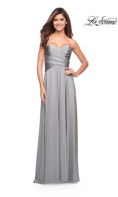 Woman in a silver Long Prom Dress: La Femme 30700 with sweetheart neckline and high-leg slit, smiling; “La Femme” logo in top right corner.
