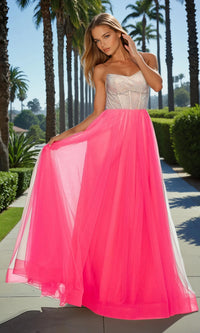 Woman wearing a strapless dress with a pink overlay in a garden setting