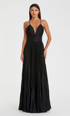 Woman wearing the Pleated Empire-Waist Long A-Line Prom Dress 30725, a sleeveless black gown with a deep V-neckline, thin straps, and pleated skirt, standing against a plain white background.