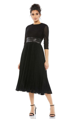 A woman wears the Mac Duggal 30750 tea-length wedding guest dress in black with pleats, three-quarter sleeves, and a metallic belt, paired with black high-heeled sandals.