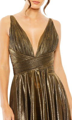 A woman wears the Mac Duggal 30761 tea-length wedding-guest dress—a sleeveless metallic bronze gown featuring a deep V-neckline and pleated bodice, perfect for an elegant metallic wedding look.