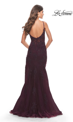 A woman shows off the La Femme Sheer-Corset-Bodice Long Prom Dress 30767, a dark purple, floor-length gown with a low back, sleeveless design, and delicate lace embroidery, posing with her back to the camera.