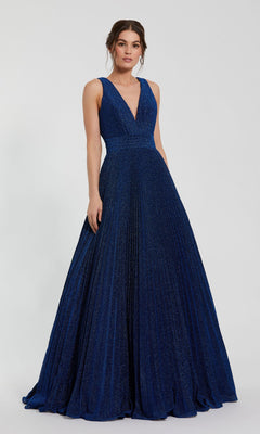 A woman in the Mac Duggal 30773 Long Pleated A-Line Prom Dress, featuring a sleeveless deep V-neck and flowing blue skirt, stands against a plain light background.