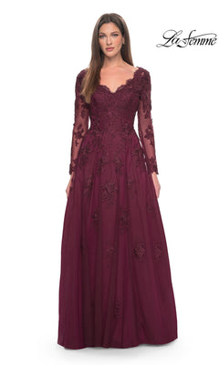 A woman wearing the Long Formal Dress: La Femme 30795 in wine, featuring a V-neckline, long sleeves, beaded lace appliques, and a tulle A-line skirt.