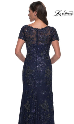 Back view of the Long Formal Dress: La Femme 30798, a navy blue short-sleeved, long formal dress with floral embroidery and sequin embellishments.