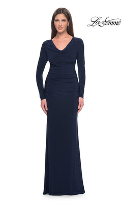 A woman wears the navy Long Formal Dress: La Femme 30813, a long-sleeve gown featuring a cowl neckline and a ruched waist.
