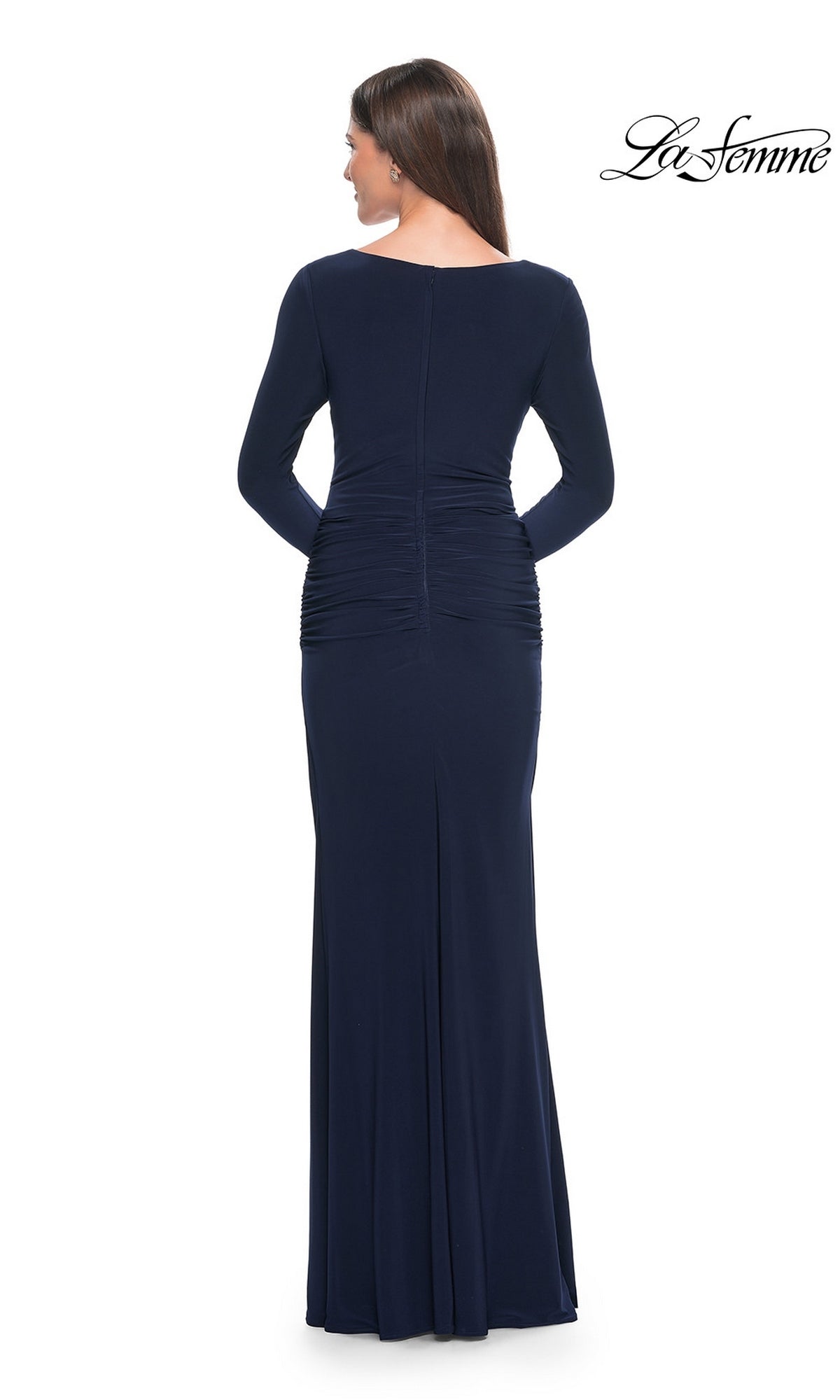 Back view of a woman wearing a navy blue La Femme 30813 long formal dress featuring long sleeves and a ruched waist.