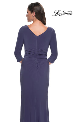 Back view of a woman wearing the smoky blue Long Formal Dress: La Femme 30814, featuring a floor-length silhouette, three-quarter sleeves, and vertical ruching down the center back.