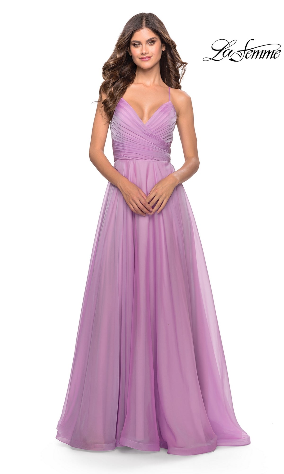 A woman wears the La Femme V-Neck Long Tulle Prom Ball Gown 30840, a sleeveless, floor-length lavender dress with spaghetti straps and a v-neckline, standing against a white background.