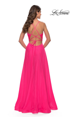 A woman is seen from behind in the La Femme V-Neck Long Tulle Prom Ball Gown 30840, featuring a bright pink color, crisscross open back, and flowing skirt. The La Femme logo is displayed in the top right corner.