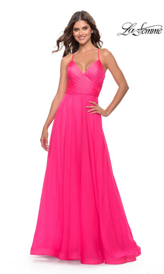 A woman smiles against a white background wearing the La Femme V-Neck Long Tulle Prom Ball Gown 30840, a bright pink, floor-length dress with spaghetti straps and a fitted bodice. The "La Femme" logo appears in the top right corner.