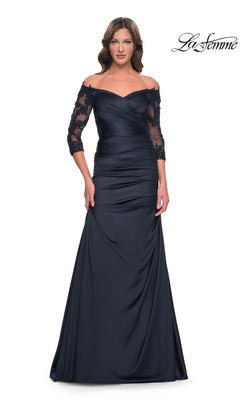 A woman wears a navy Long Formal Dress: La Femme 30853, an off-the-shoulder gown with three-quarter length lace sleeves and a ruched bodice.