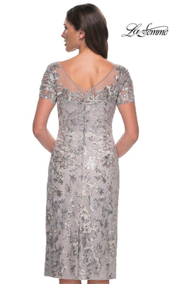 Back view of a Knee Length Wedding Guest Dress: La Femme 30854, a silver dress with short sleeves, silver floral embroidery, sequins, and a sheer illusion neckline.