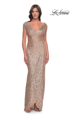 A woman wears a rose gold La Femme 30865 long formal dress featuring a V-neck, cap sleeves, and a wrap-style floor-length sequin skirt.