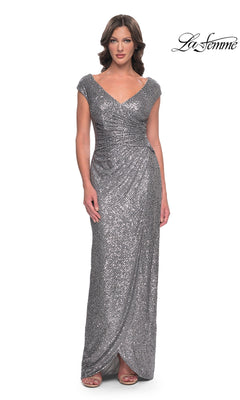 La Femme 30865 is a floor-length, silver sequined sheath dress with a V-neckline and cap sleeves.
