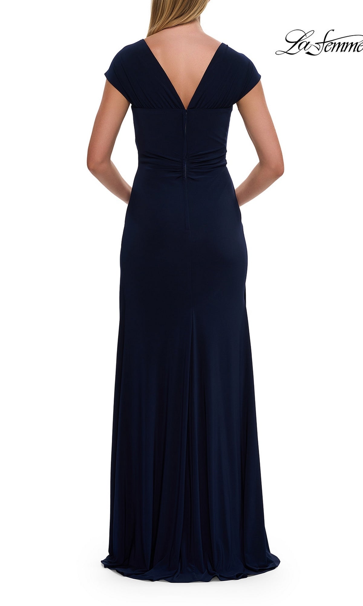 A woman is seen from the back wearing the La Femme 30874 Cap-Sleeve Long Jersey Formal Dress in navy blue, which features cap sleeves, a fitted waist, and a deep V-shaped back for an elegant and refined silhouette.