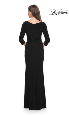 A woman is shown from the back in the La Femme Sleeved Simple Jersey Formal Dress 30967, a long black dress with three-quarter sleeves, set against a white background. "La Femme" logo appears in the upper right corner.