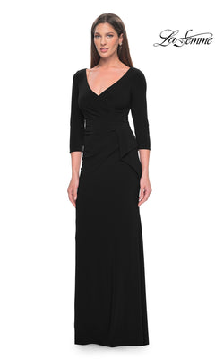 A woman stands against a white background wearing the La Femme Sleeved Simple Jersey Formal Dress 30967, a long black V-neck design with three-quarter sleeves. The "La Femme" logo appears in the top right corner.