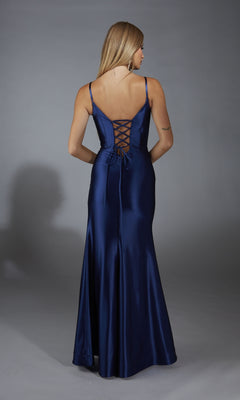 A woman in the Long Navy Blue Prom Dress: Aerie Couture 309, featuring a corset bodice, lace-up back, thin straps, and a floor-length satin skirt, stands against a plain gray background.