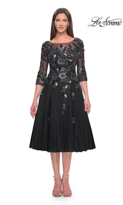 The La Femme 31017 midi wedding guest dress in black features three-quarter sleeves, a sheer neckline, and sequined floral appliques on the bodice over an A-line tulle skirt.