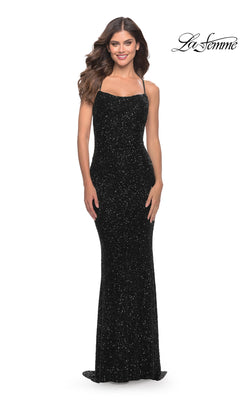 A woman smiles in an Open-Back La Femme Long Sequin Prom Dress 31027—black, floor-length with thin straps—posing against a plain white background. The "La Femme" logo appears in the top right corner.