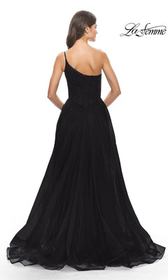 A woman with her back turned highlights the full skirt and fitted, sheer bodice of the One-Shoulder Sheer-Bodice Prom Ball Gown 31069. The La Femme logo is displayed in the top right corner.