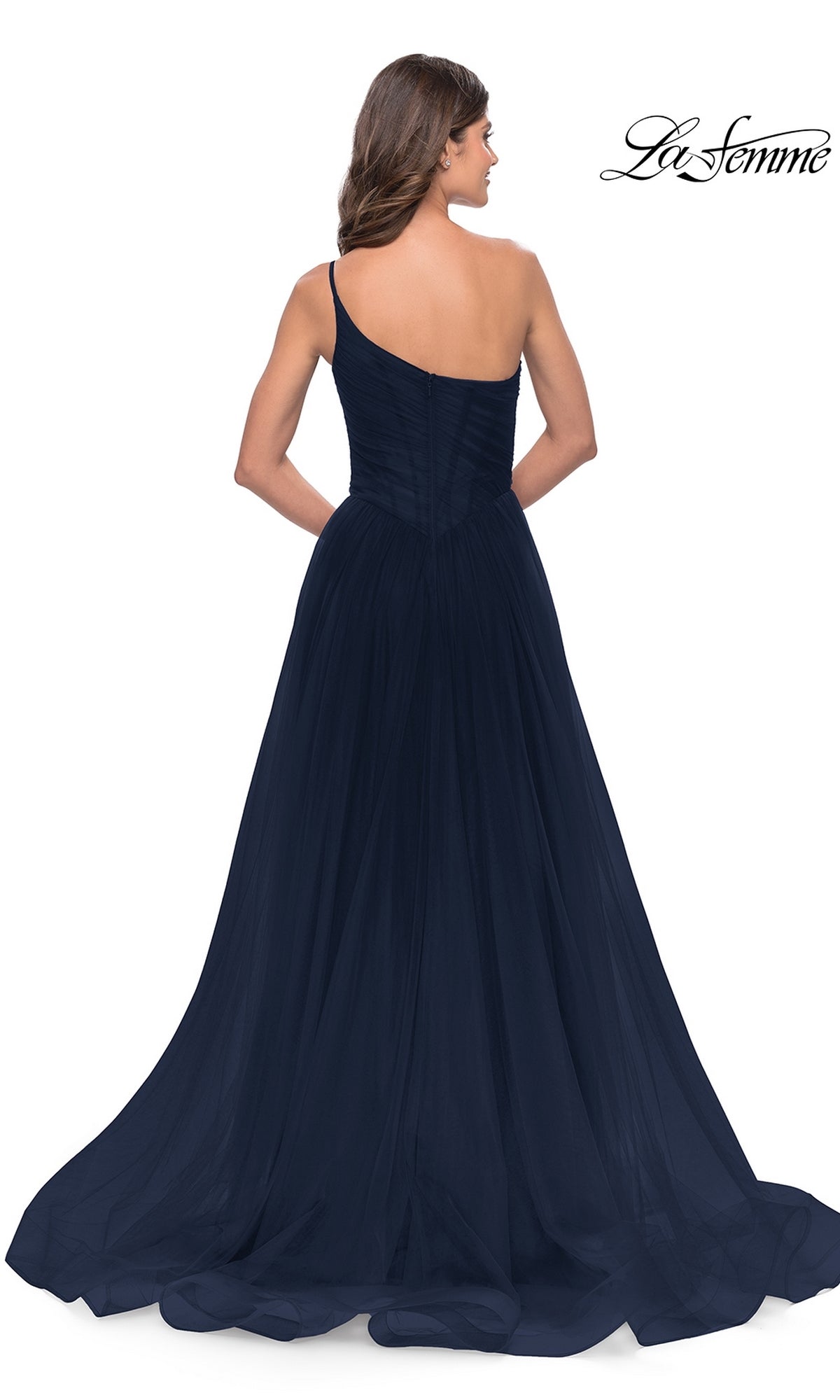 Woman in a navy One-Shoulder Sheer-Bodice Prom Ball Gown 31069, featuring a fitted bodice and flowing floor-length skirt, photographed from the back.