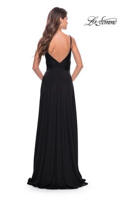 A woman in the La Femme Simple Long A-Line Prom Dress 31090, featuring a deep V-back and ruched bodice, stands facing away from the camera. The "La Femme" logo appears in the top right corner.