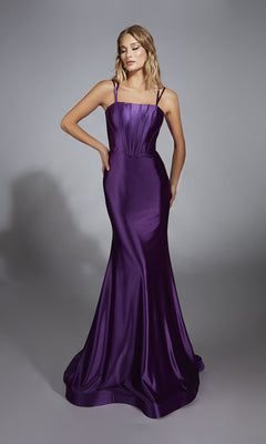 A woman poses against a plain gray background, wearing the Aerie Couture 310 open-back long prom dress—a sleeveless, floor-length gown in purple with a mermaid silhouette and flared hem.