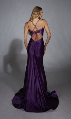 A woman faces away in the Aerie Couture 310, an open-back long prom dress featuring deep purple satin, a mermaid silhouette, crisscross tie-back design, and slight train, posed against a plain gray background.
