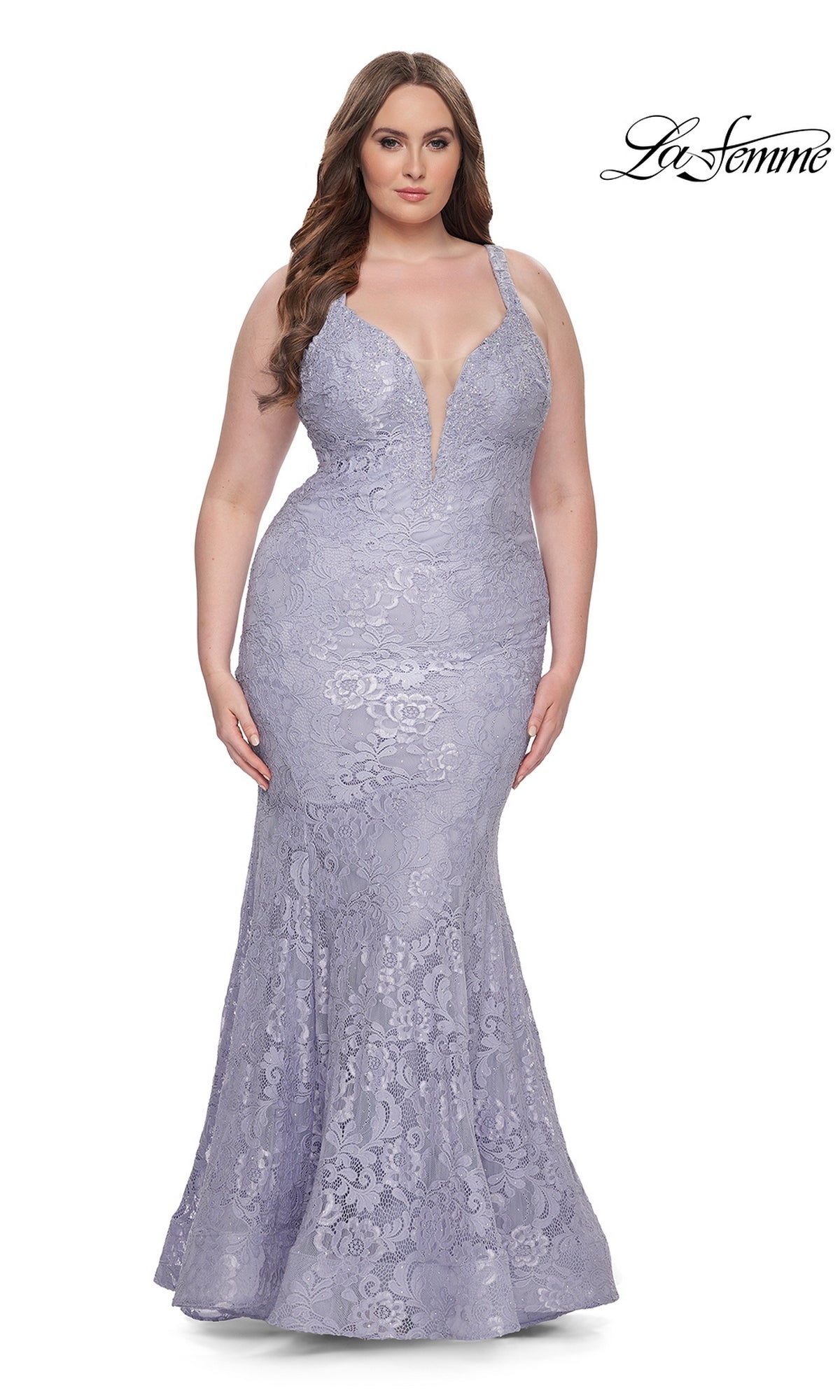 A woman stands against a white background wearing the La Femme Long Prom Dress 31118, a fitted lavender lace mermaid gown with thin straps, a deep V neckline, and a floor-length hem.