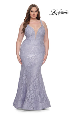 A woman stands against a white background wearing the La Femme Long Prom Dress 31118, a fitted lavender lace mermaid gown with thin straps, a deep V neckline, and a floor-length hem.