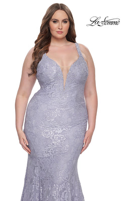 A woman wears the La Femme Long Prom Dress 31118, a light lavender lace gown featuring a deep V-neckline, fitted bodice, and mermaid silhouette. The La Femme logo is displayed in the top right corner.