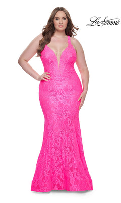 A woman in the La Femme Long Prom Dress 31118—bright pink, lace, with a deep V neckline—stands against a white background. The La Femme logo appears in the top right corner.