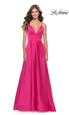 A woman in the La Femme Bright Long A-Line Prom Dress 31121, featuring spaghetti straps and a deep V neckline, stands smiling against a plain white background.