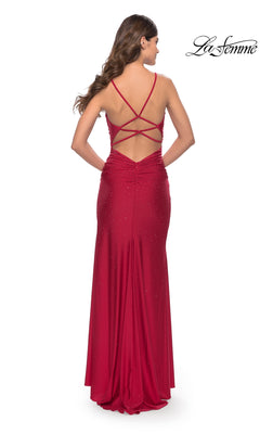 A woman models the La Femme Cowl-Neck Long Beaded Prom Dress 31123, showcasing its cowl neckline, subtle embellishments, crisscross strappy open back, and long silhouette while standing with her back to the camera.