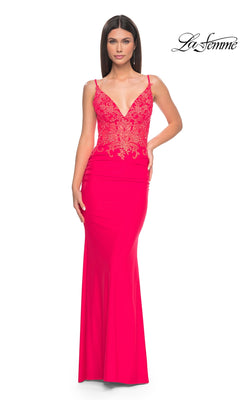A woman wears the La Femme Sheer-Waist Long V-Neck Prom Dress 31128 in hot coral, featuring a fitted embroidered-lace bodice, deep V-neckline, and floor-length sleeveless silhouette for a glamorous, form-fitting look.