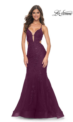 A model wearing the Long Prom Dress: La Femme 31132 in dark berry, featuring a floor-length silhouette, plunging neckline, cutout sides, and beaded lace appliques.