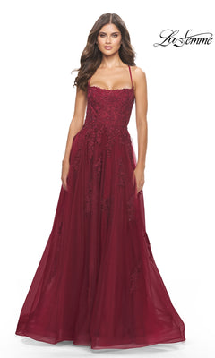 A woman models the La Femme Long A-Line Lace Prom Ball Gown 31135— a sleeveless, floor-length burgundy embroidered lace dress with thin straps and a fitted bodice—against a white background.