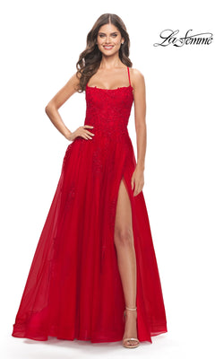 Woman in a red La Femme Long A-Line Lace Prom Ball Gown 31135, featuring a sleeveless design, open back, thigh-high slit, fitted embellished bodice. She stands smiling with the "La Femme" logo in the top right corner.