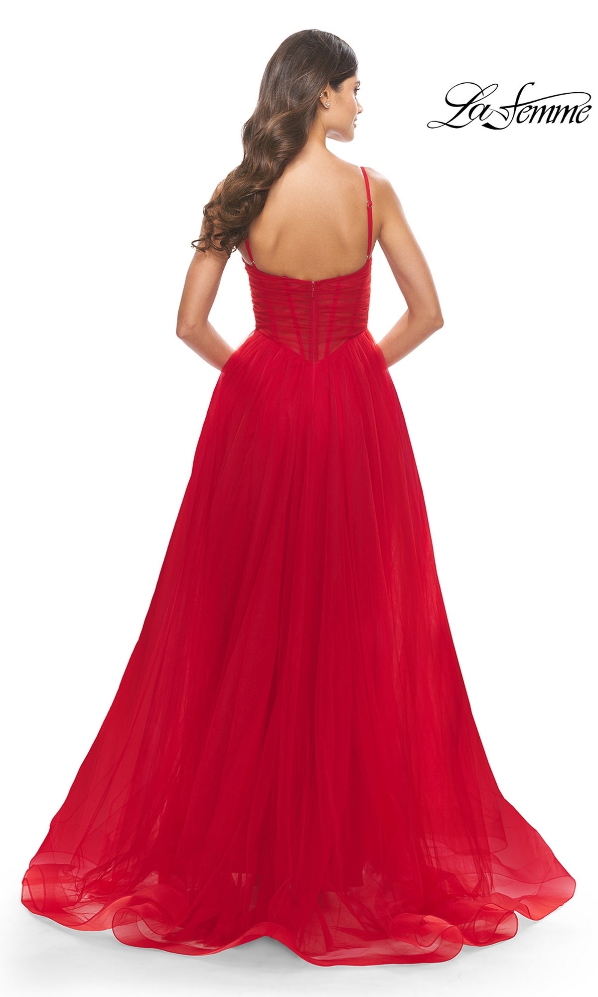 Woman shown from the back wearing the Sheer-Waist La Femme Long Prom Ball Gown 31147—a flowing red ball gown with thin straps and a fitted bodice—standing against a white background.