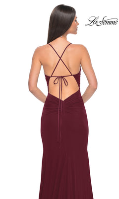 Woman shown from behind in the La Femme Sheer-Waist Long Prom Dress 31151, a sleeveless, floor-length burgundy gown featuring an open back with crisscross straps.